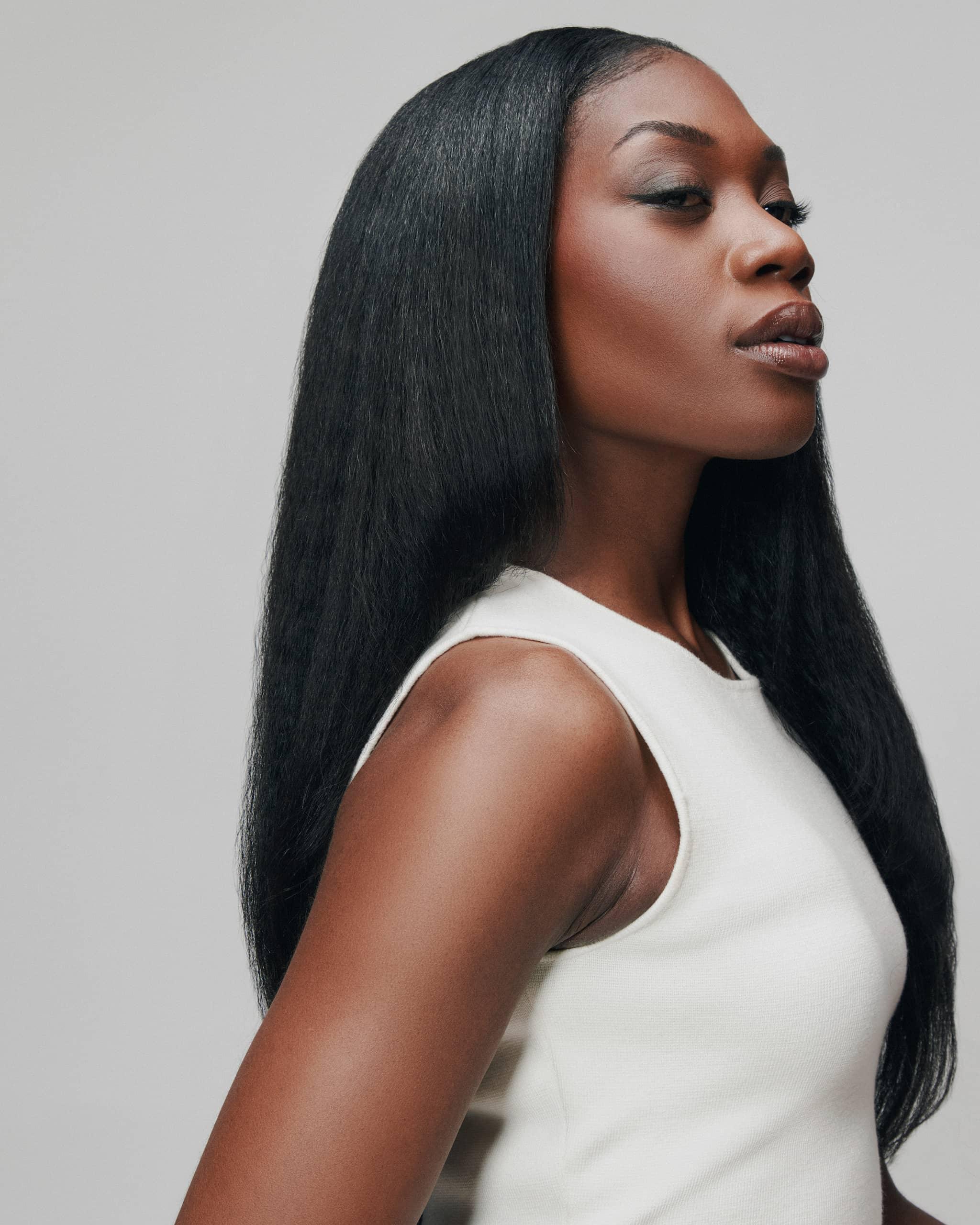 Side view of model wearing Star Girl refined Cambodian blowout texture hair bundles by SOWN, resembling Type 4 hair