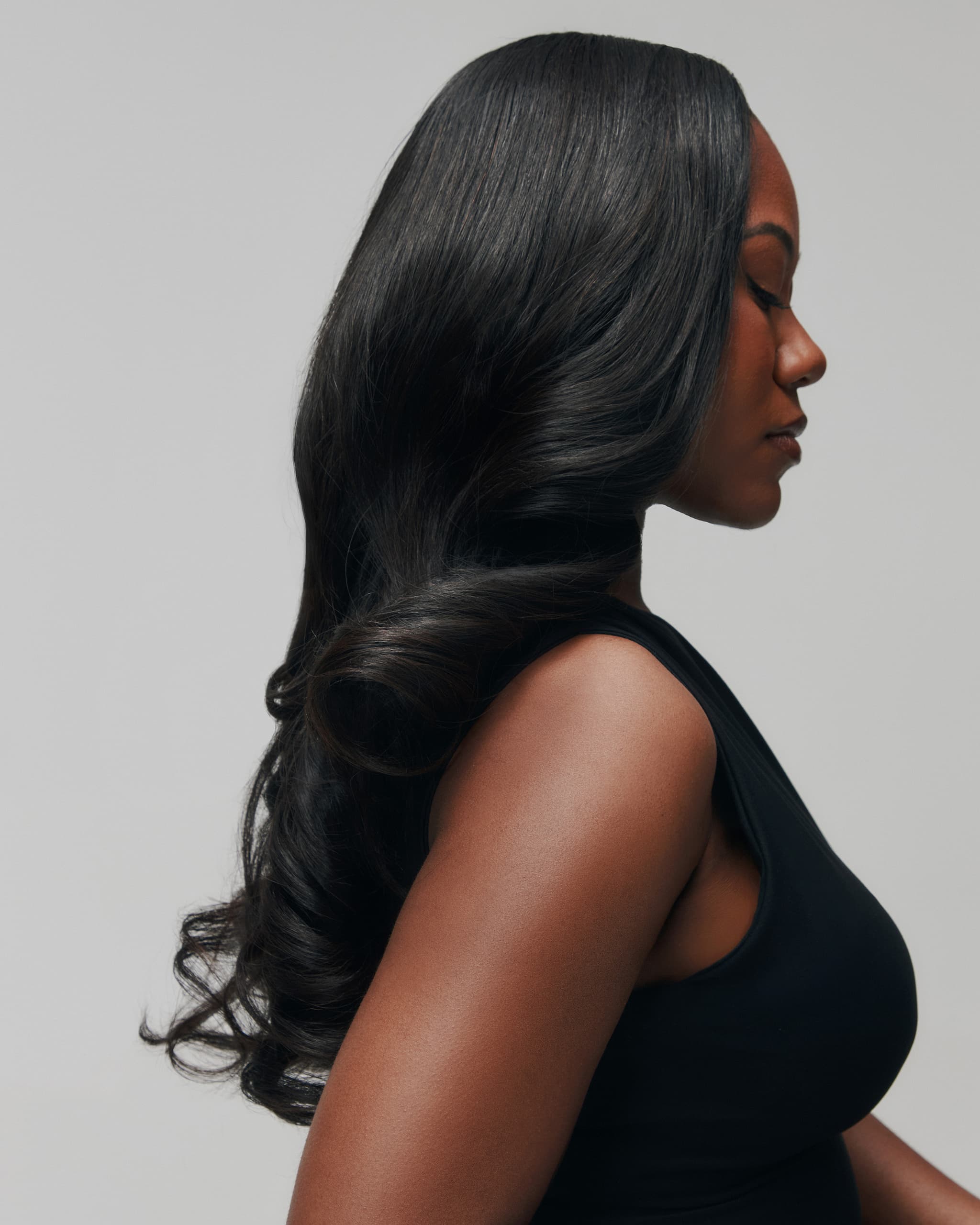 Side profile of model wearing Trophy by SOWN, showing the natural flow and volume of the Vietnamese body wave texture. Soft and Type 3-inspired.